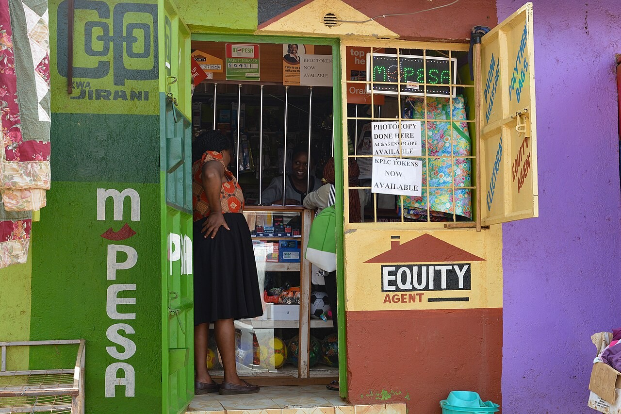 An M-PESA agent shop in Nairobi, Kenya. File photograph of the payment ecosystem; not the OneApp flight-booking screen.