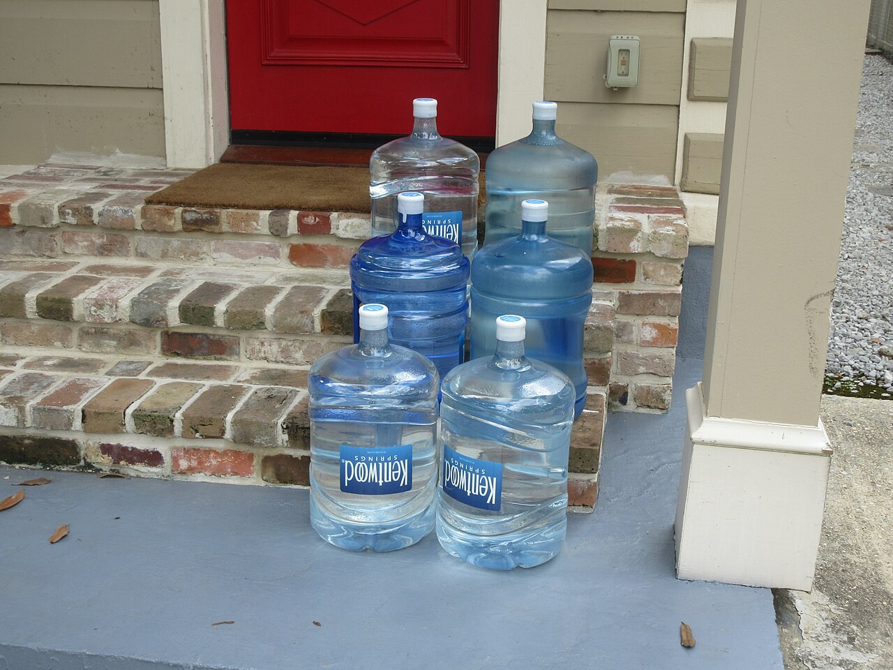 Water jugs on a doorstep in New Orleans, photographed in September 2026. File illustration of packaged water, not Nestlé products or Nigerian operations.