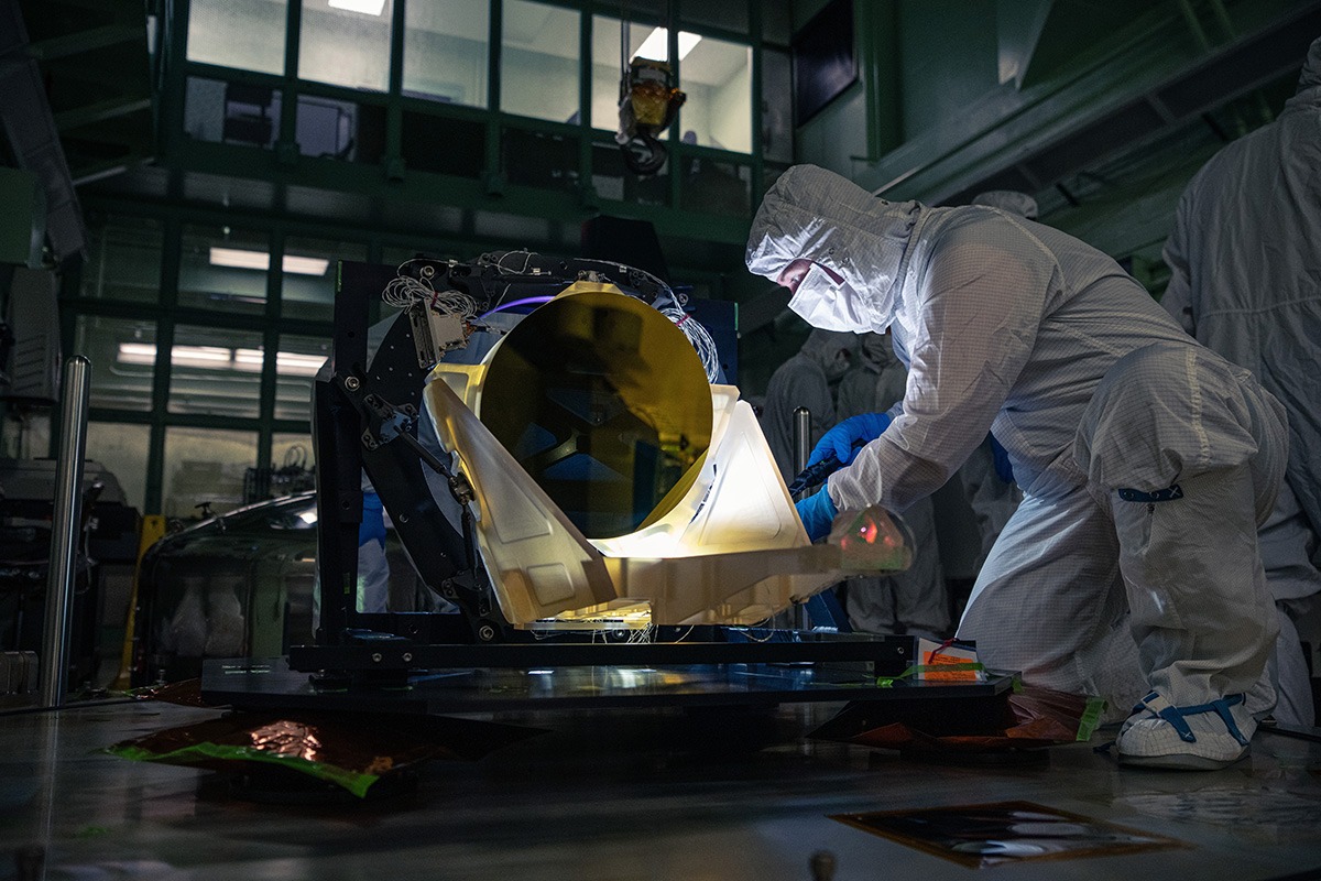 A technician inspects LISA's prototype glass-ceramic telescope in May 2024. NASA/Dennis Henry. Historical test-hardware photograph, not a telescope already operating in space.