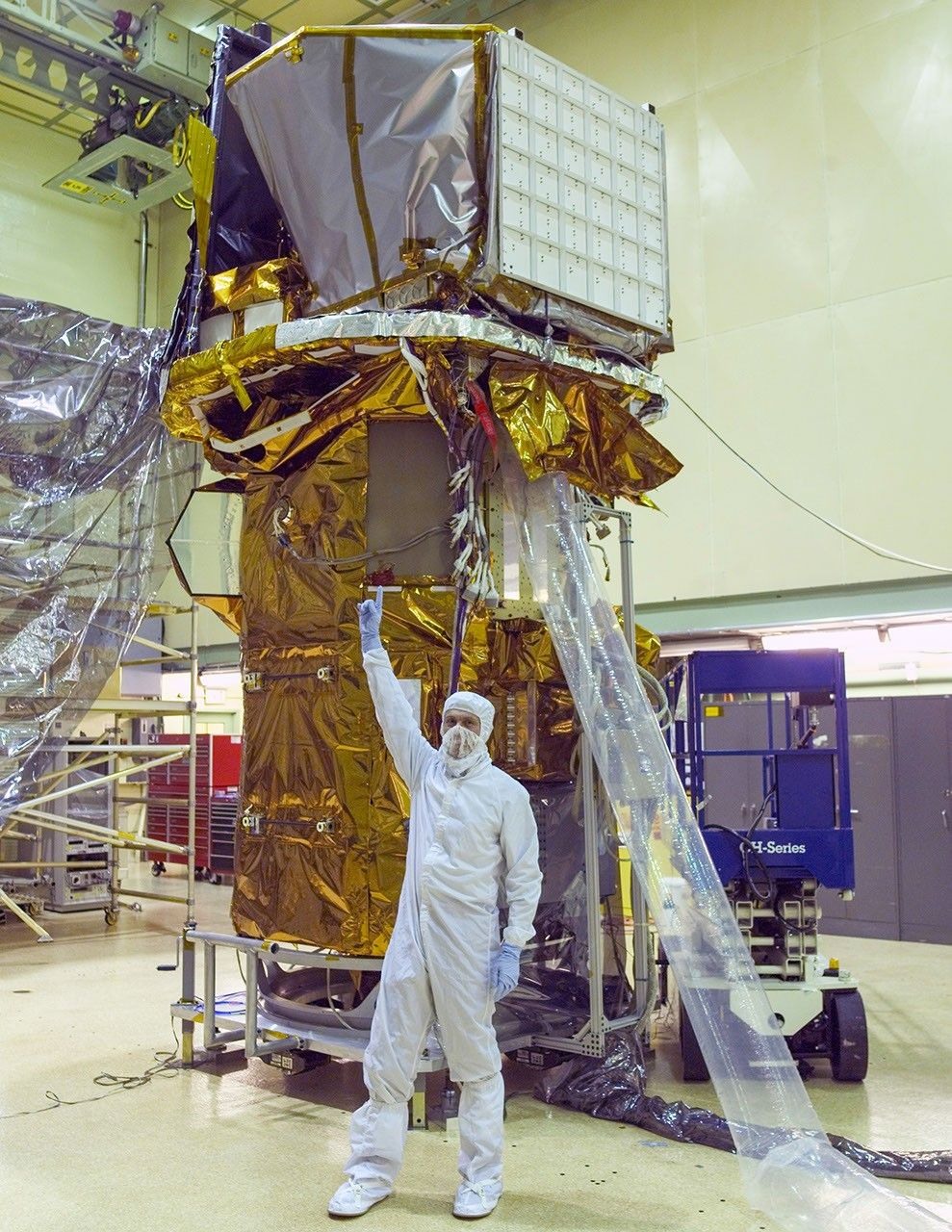 Neil Gehrels with the completed Swift spacecraft in a NASA clean room on September 9, 2003. Historical photograph, not the mission's final days in orbit.