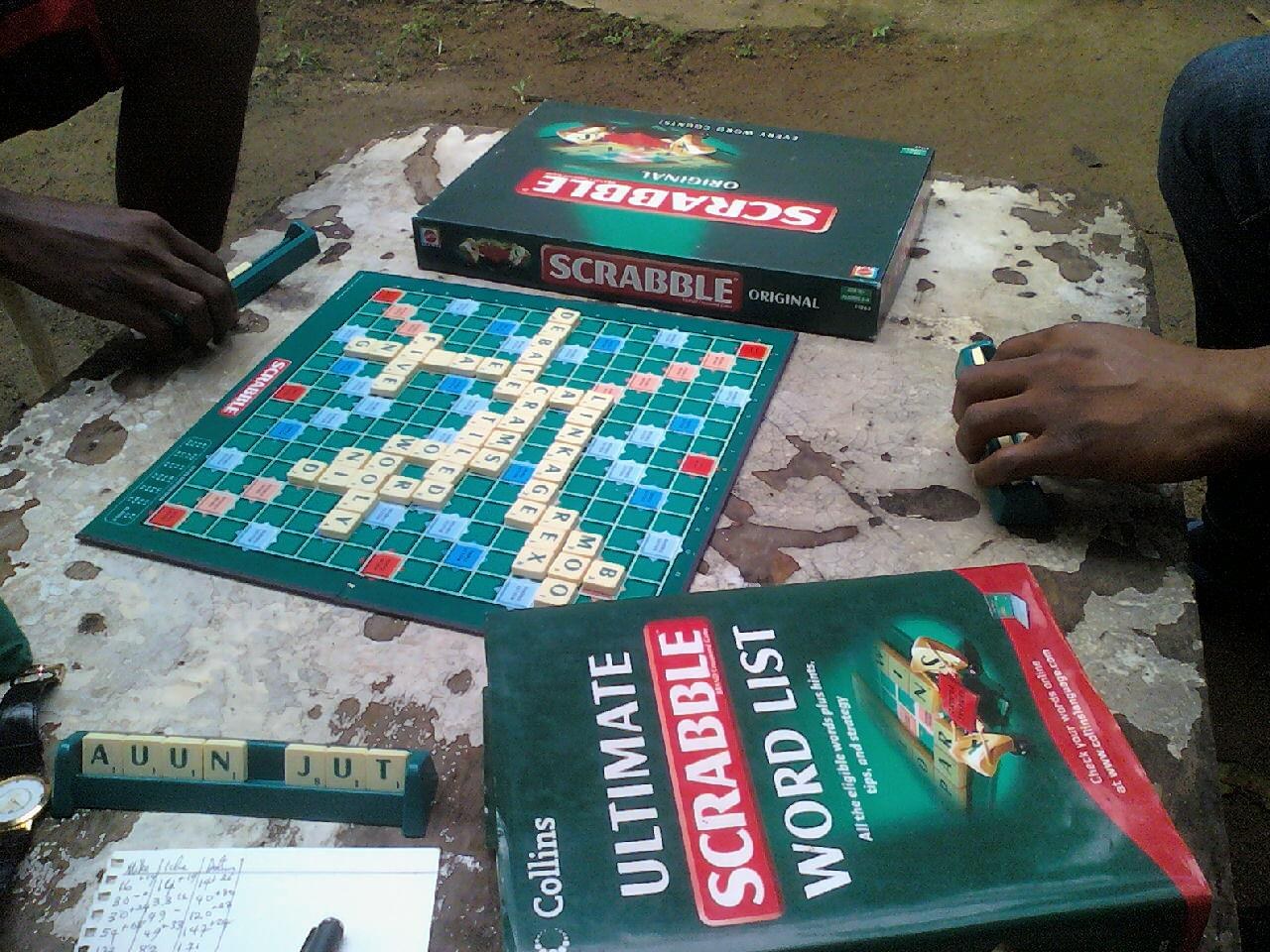 A three-player Scrabble game with a dictionary. File photograph, not the African championship in Monrovia.