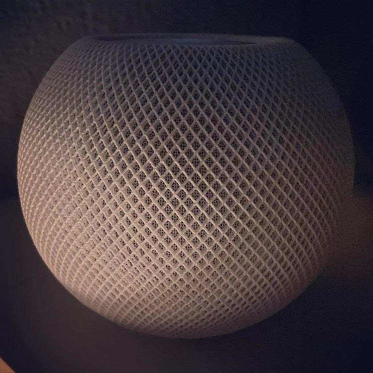 An Apple HomePod mini speaker, illustrating the company's connected-home products. It is not HomeView.