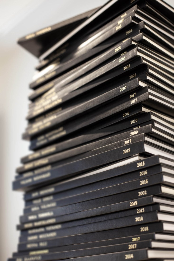 Bound academic theses displayed at Atostek's office. File photograph illustrating research documentation; these are not Nigerian prize entries.